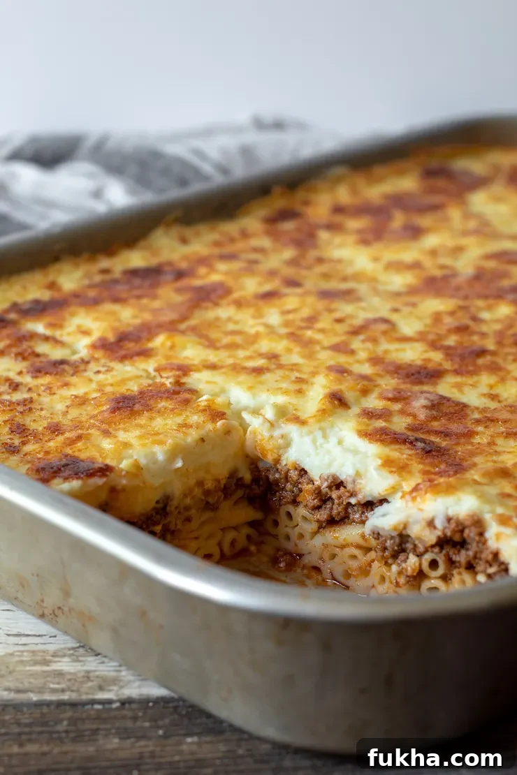 Pastitsio Recipe: Classic Greek Baked Pasta with Bechamel 5 Baked pastitsio in pan showing layers.
