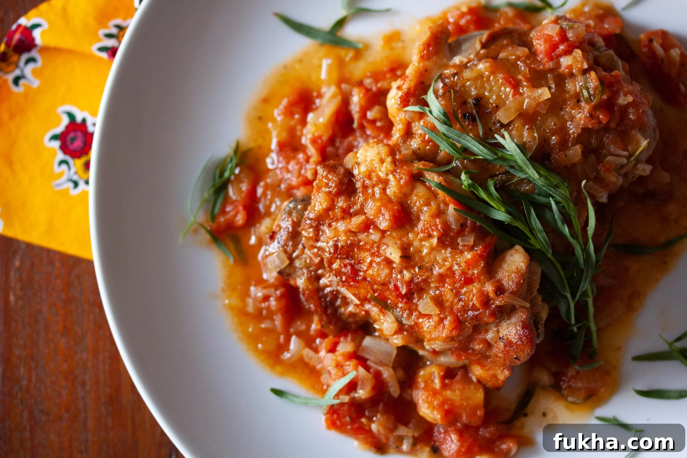 tarragon chicken served on a white plate