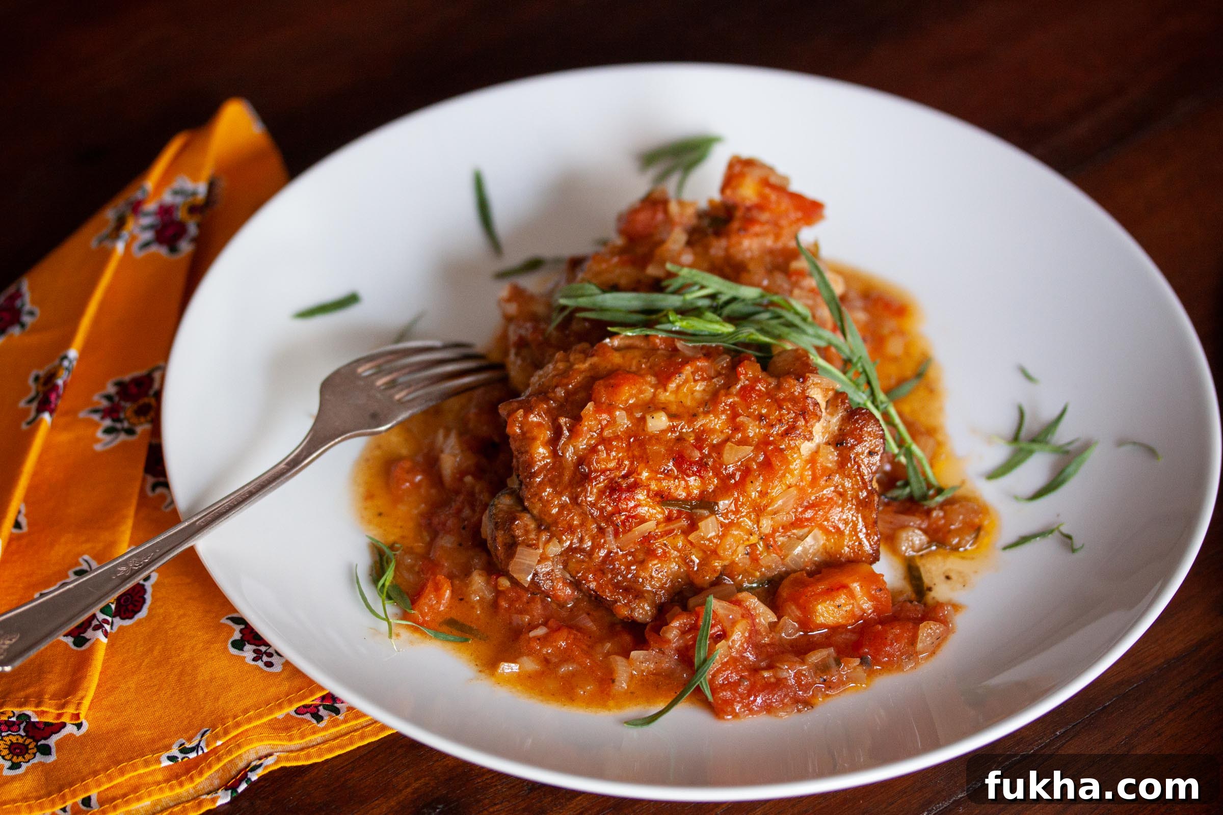 tarragon chicken on a white serving plate