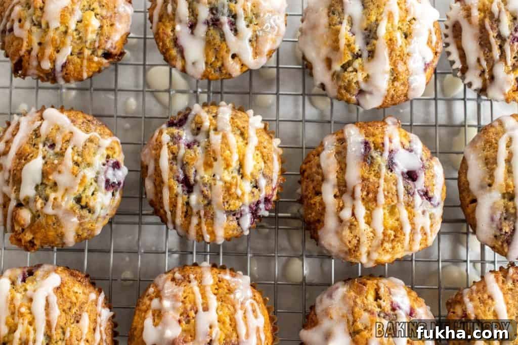 raspberry white chocolate muffins on wire rack being glazed