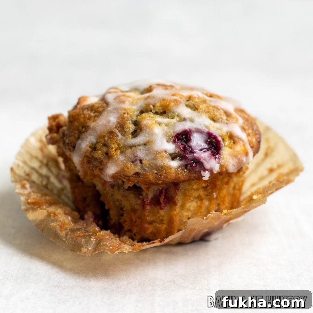 one of the raspberry white chocolate muffins recipe resting on its wrapper