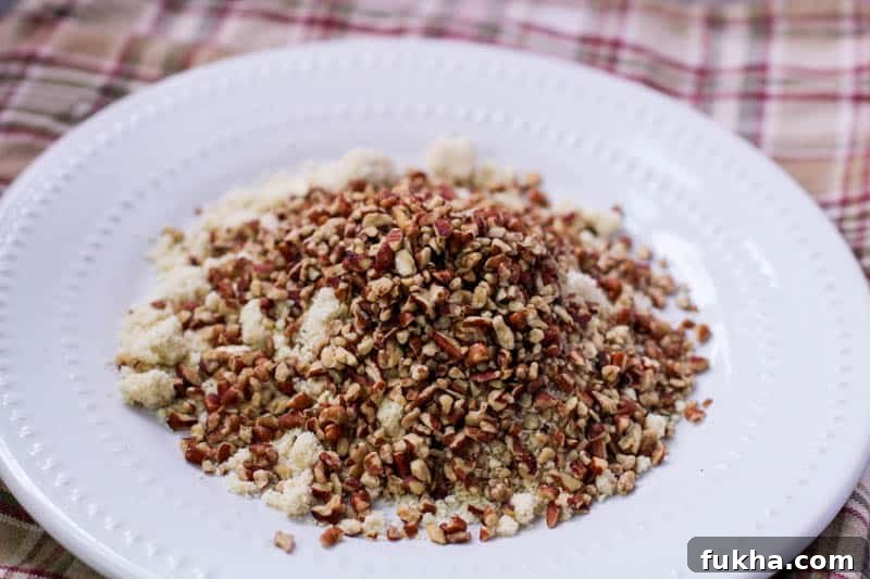 Crushed pecans and almond flour on a plate for low carb pumpkin cheesecake balls