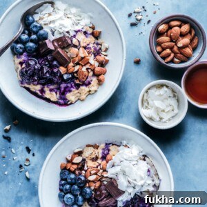 bowls of oatmeal with stewed blueberries, almonds, and coconut