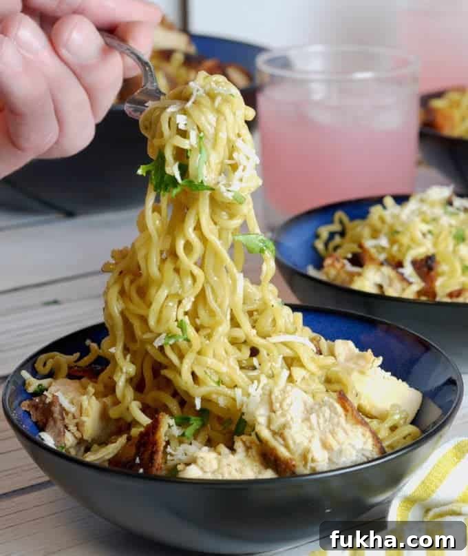 Eating chicken ramen noodles with a fork.