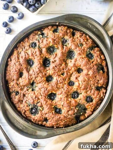 Blueberry breakfast cake baked in a round cake pan.