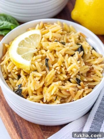 One-Pot No-Boil Mac and Cheese 12 Ramekin filled with lemon parmesan orzo topped with a half lemon slice.