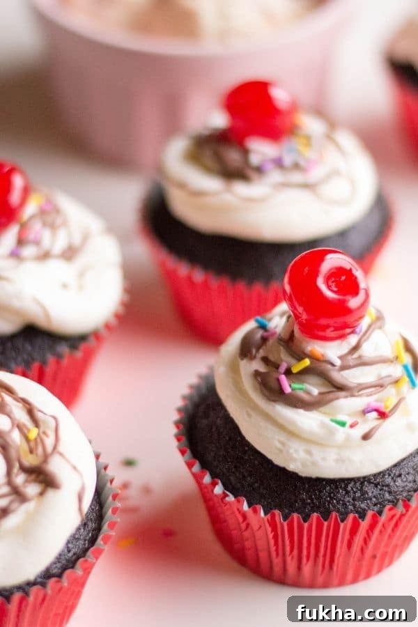 hot fudge sundae decorated cupcakes sitting on table 