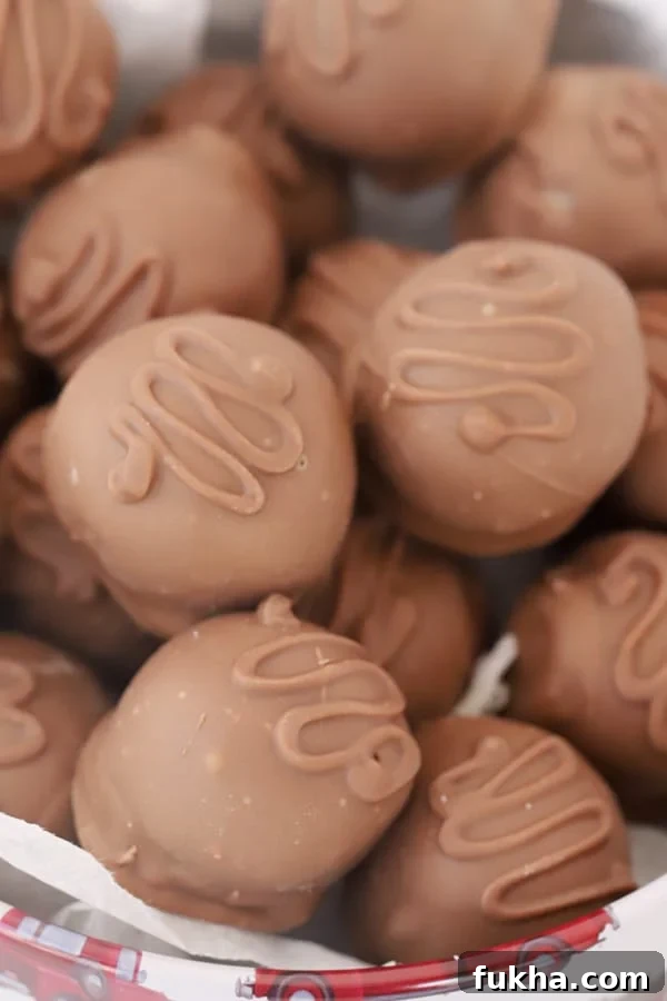 Chocolate-Covered Coconut Balls Recipe: Bite-Sized Truffles 5 A bowl full of coconut balls dipped in chocolate.
