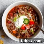 Slow-Cooker Beef Chili Recipe with Rich Smoky Flavor 8 Overhead close-up of a bowl of slow cooker beef chili.