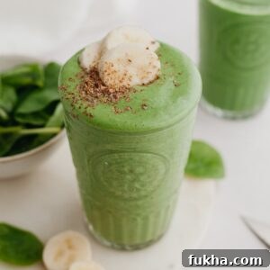 Banana spinach smoothie in a large glass