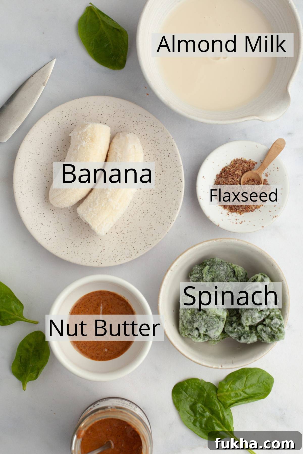 Ingredients for banana spinach smoothie arranged in small bowls