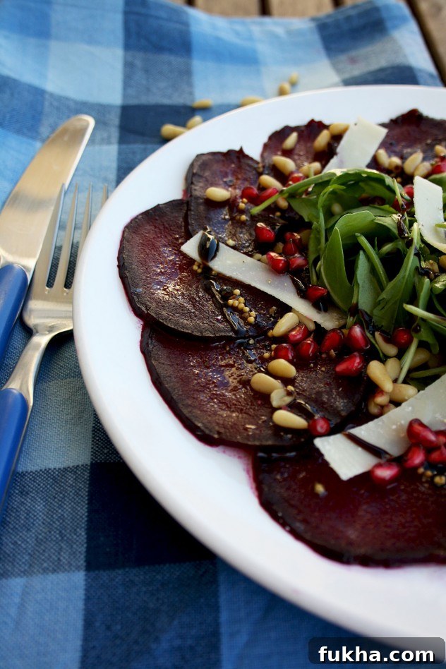 A beautiful, effortless, healthy and flavorful beetroot carpaccio with orange mustard vinaigrette and pomegranate seeds, served with parmesan and arugula.