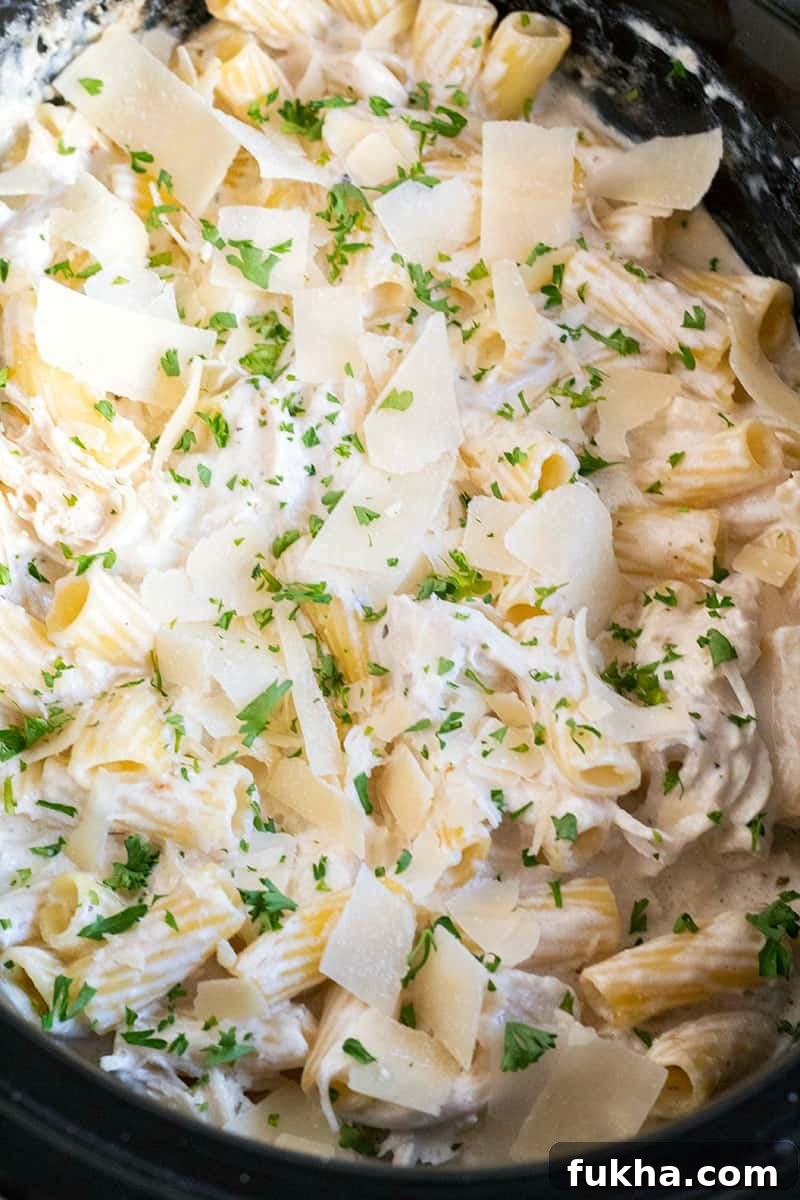 Crock Pot Chicken Alfredo topped with parsley and parmesan