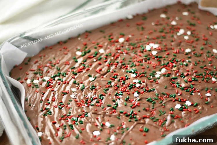 fantasy fudge with holiday sprinkles in glass pan