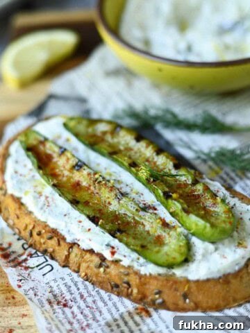 Grilled cucumber toast on a wood board.