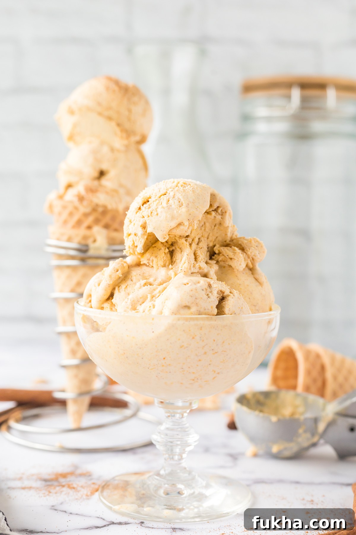 Scoops of Pumpkin Ice Cream in glass bowl.