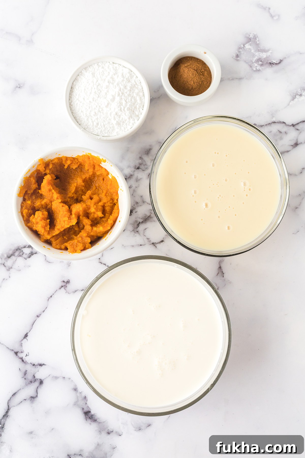Ingredients for pumpkin ice cream set out on counter top.