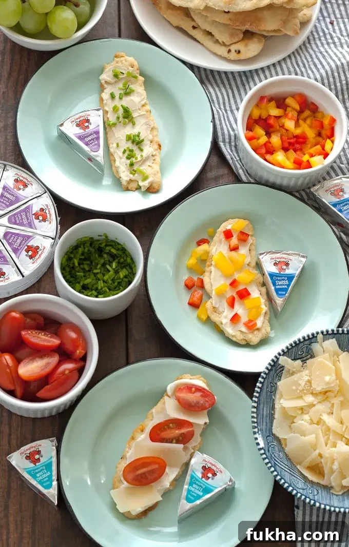 Crackers topped with soft cheese and fresh vegetables