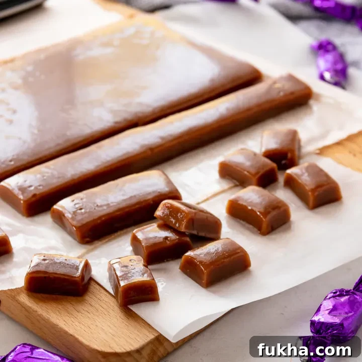 chai tea caramels on a cutting board. some are wrapped, others are not