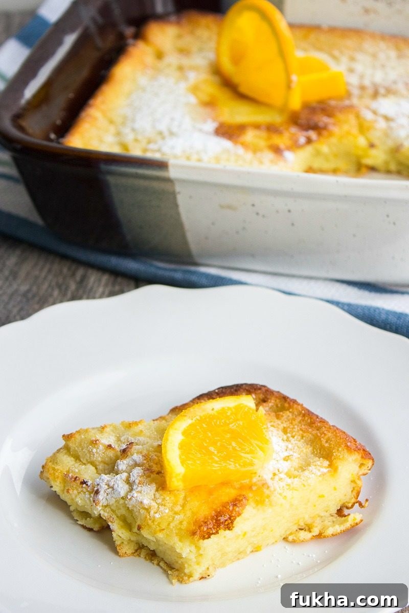A classic breakfast dish bursting with citrus flavor, this Orange Ricotta Dutch Baby Recipe is a toothsome dish that'll leave everyone asking for seconds! a slice of orange ricotta dutch baby on a plate