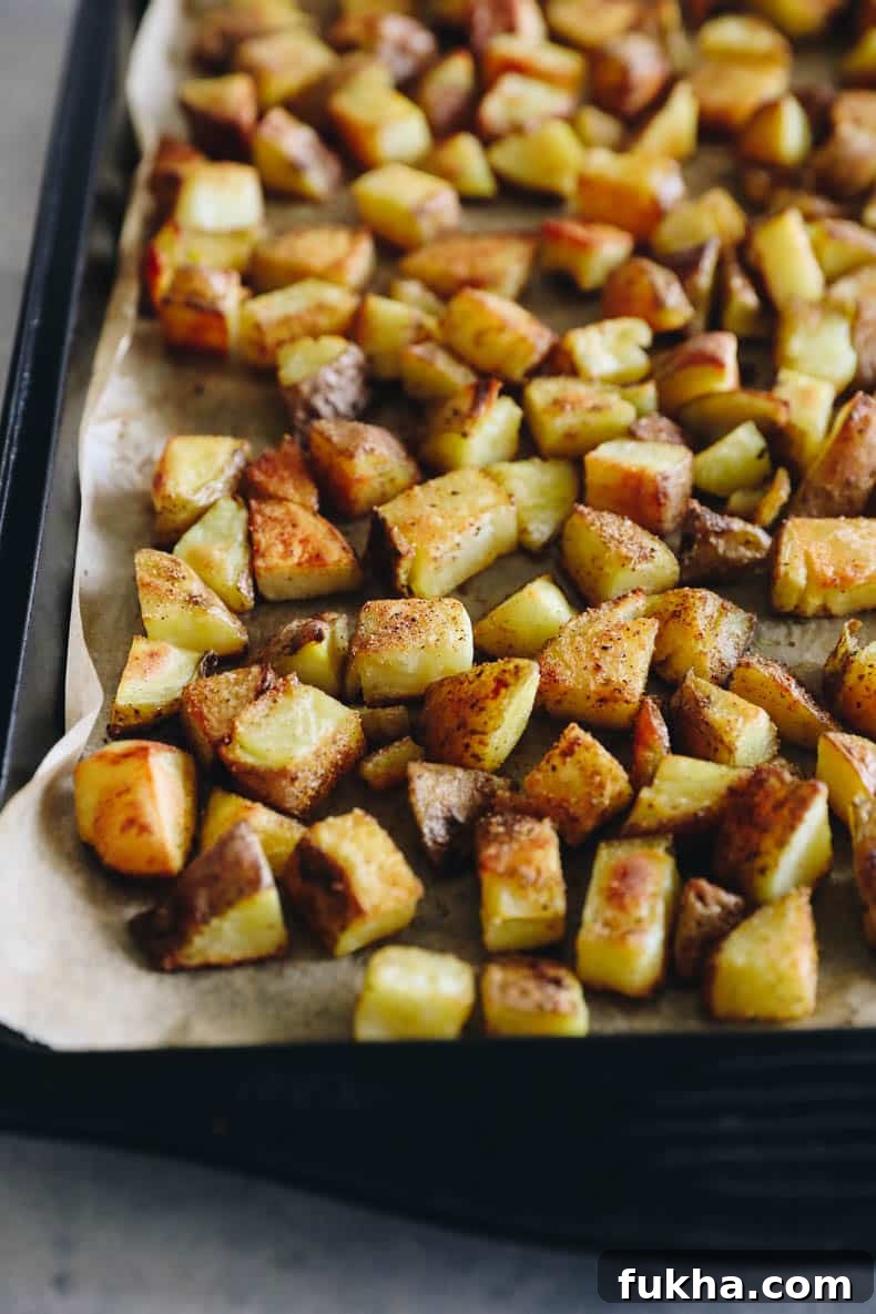 Crispy Roasted Potatoes: Oven and Air Fryer Methods 6 crispy roasted potatoes on a baking sheet.
