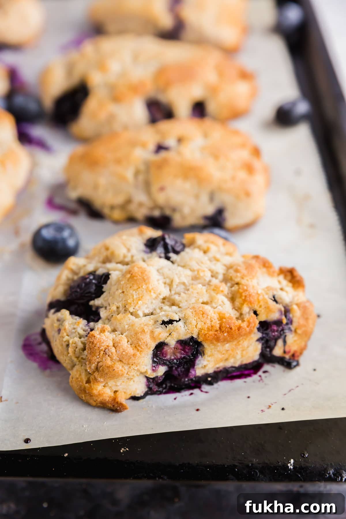 A baking sheet with gluten-free blueberry scones fresh from the oven.