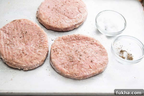 Season frozen turkey Pattie on a cutting board