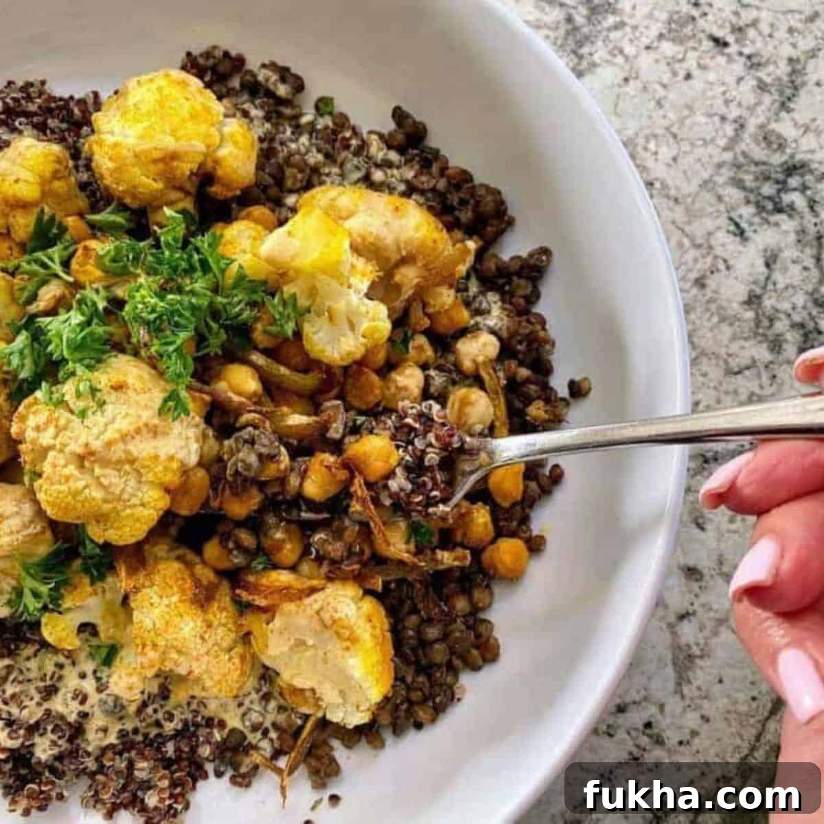 Curried Cauliflower Recipe I am eating a curried cauliflower recipe with a fork.
