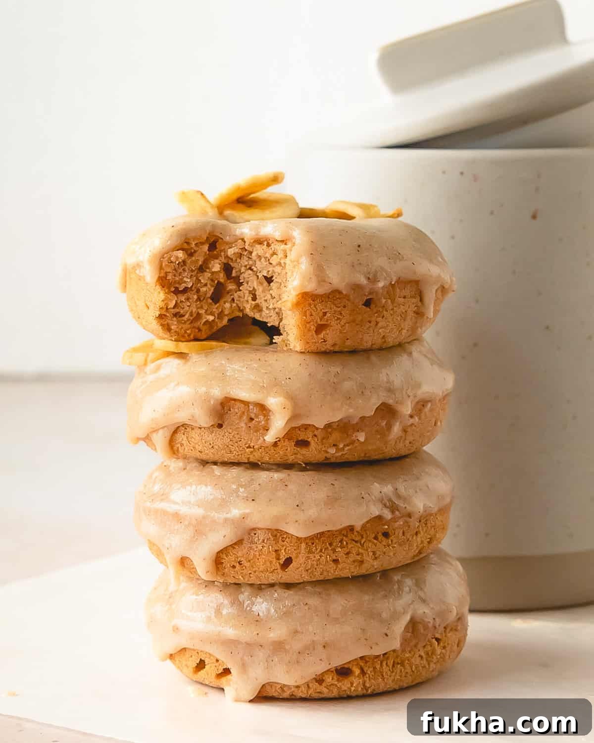 Banana Donuts with brown butter glaze in a stack.