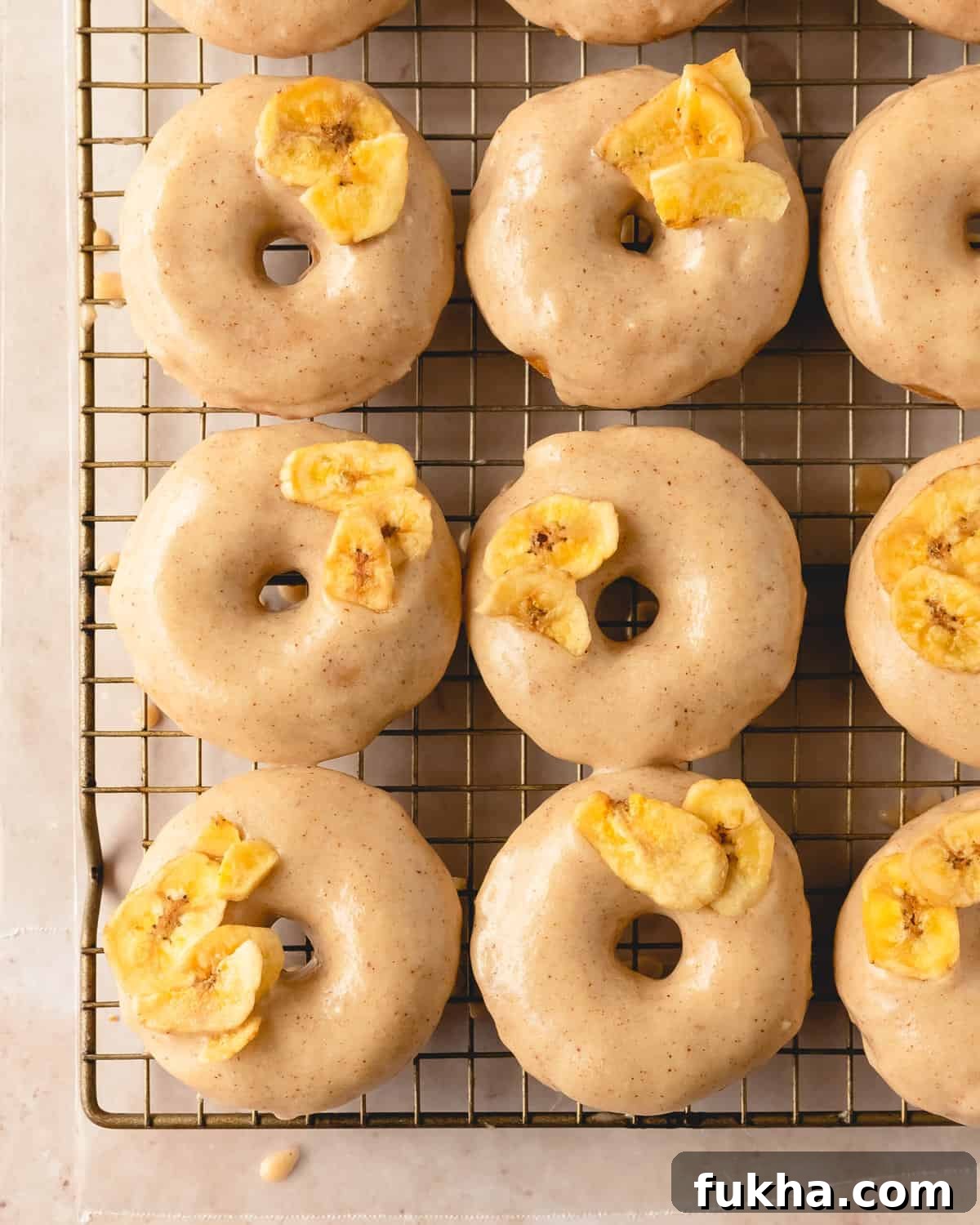 Banana donuts with brown butter glaze and banana chips on top. 