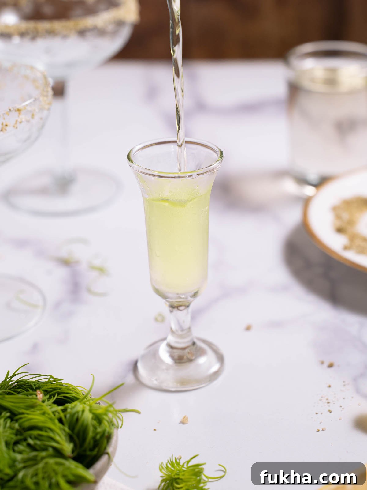 Pouring fir tip vodka into a shot glass