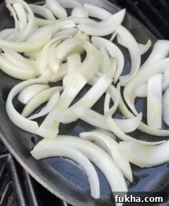 Dwaeji Galbi Pork Ribs Recipe (Ham Ji Park Copycat) 7 Ribs on hot skillet with onions