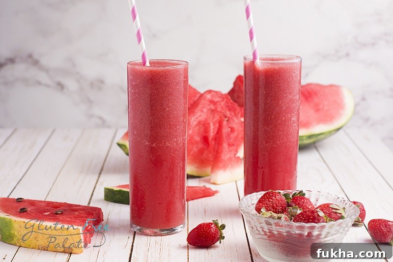 two glasses filled with strawberry watermelon smoothie