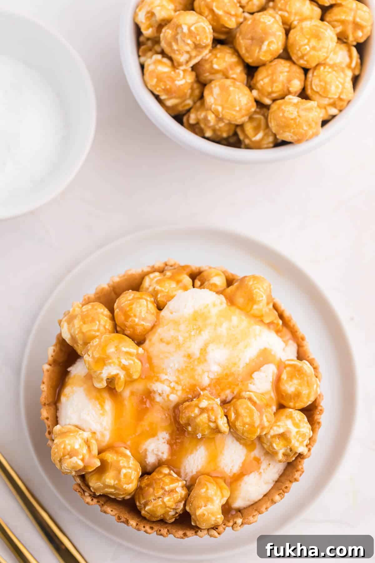Caramel Crunch Ice Cream Sundae Recipe 4 Caramel crunch ice cream sundae on a white plate.
