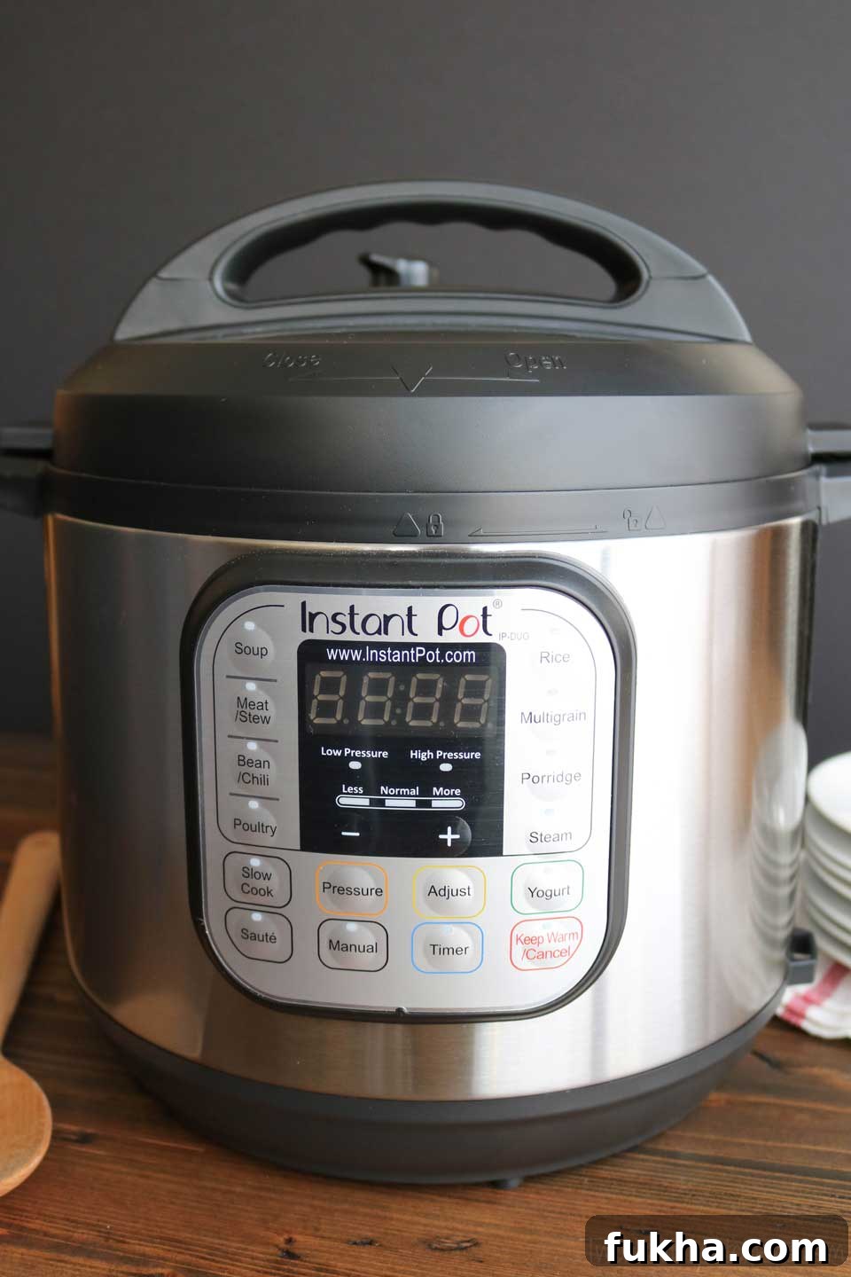 The Instant Pot - a multi-cooker electric pressure cooker, displayed with plates