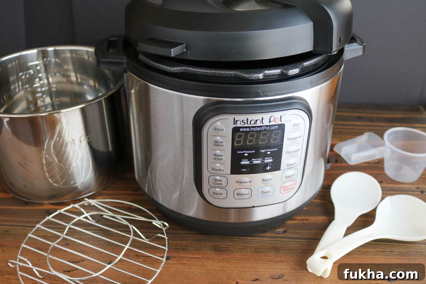 Instant Pot with all the things an Instant Pot comes with - stainless steel inner pot, steaming rack, condensation collector, rice paddle, soup spoon and measuring cup