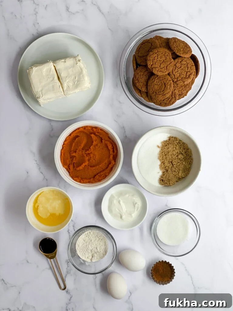 all ingredients needed to make pumpkin cheesecake bars with gingersnap crust