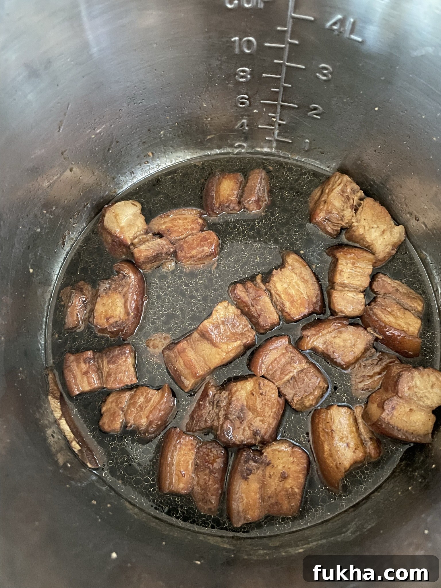 Diluted soy sauce chicken mixture added to pork belly. Diluted soy sauce chicken mixture added to pork belly.