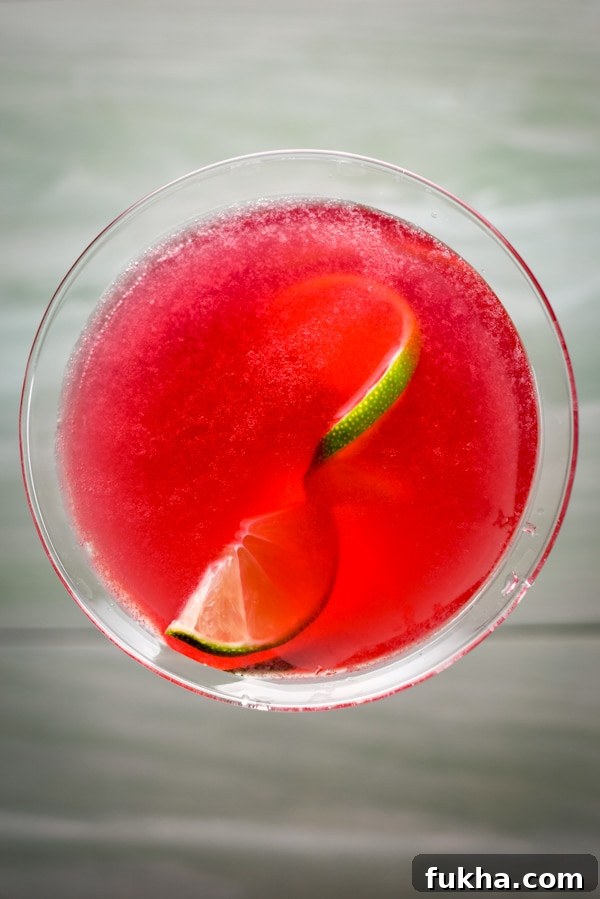 Pomegranate Cosmo Cocktail Recipe 8 Overhead view of the red drink with lime in it