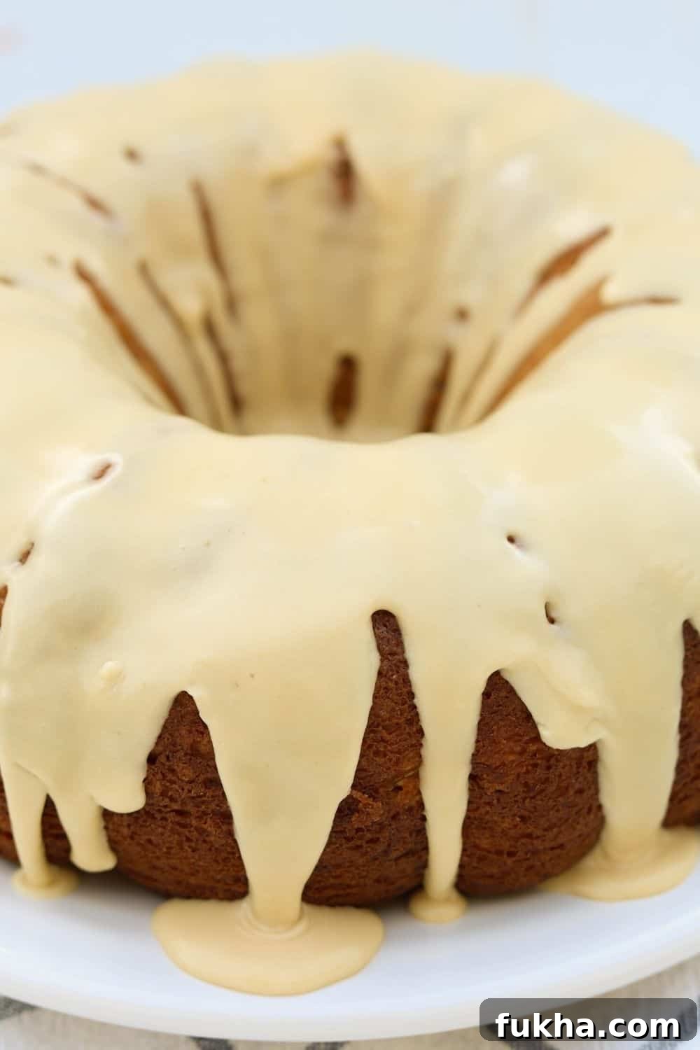 close-up view of the brown sugar caramel icing drizzled over the pear cake.