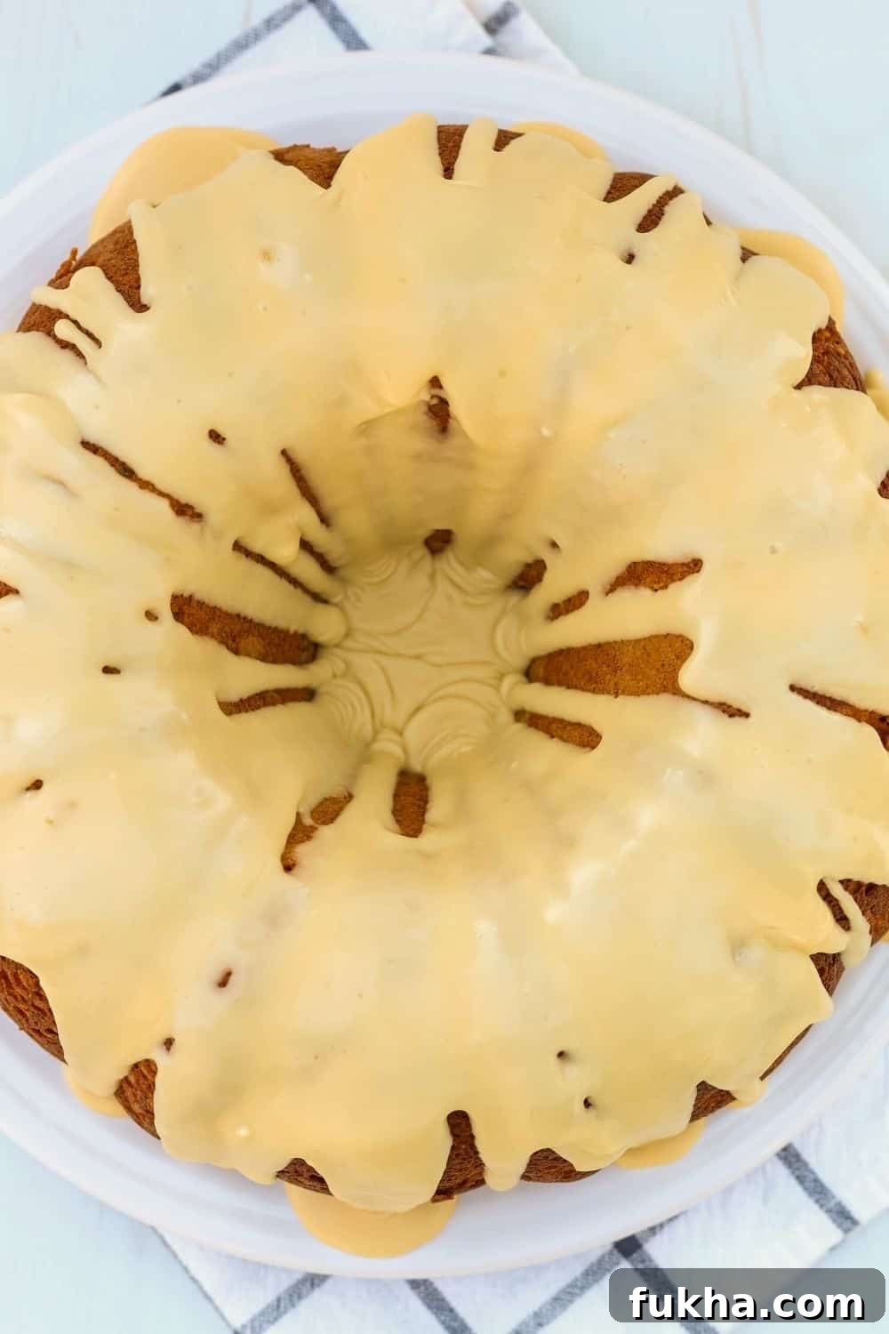overhead view of a whole cake mix pear bundt cake with icing, served on a white plate