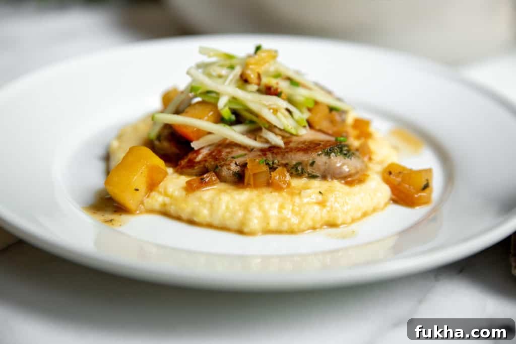 Pork medallions on a bed of polenta, topped with apple slaw.