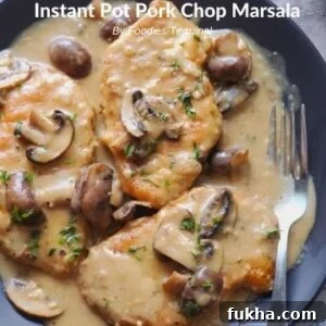 Instant pot pork chop marsala served in a black plate with a fork on the side