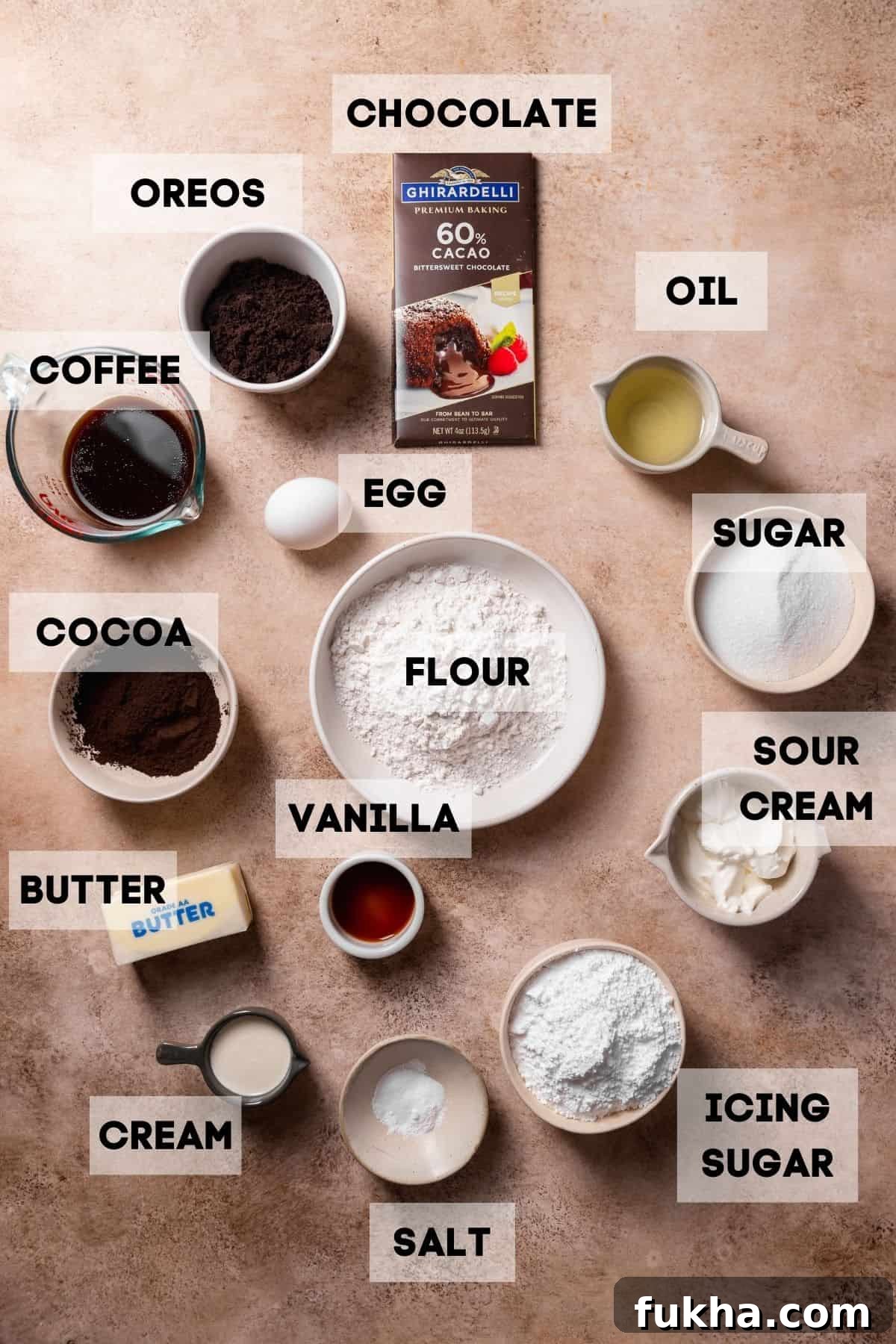 Ingredients needed to make oreo cupcakes in bowls with labels.