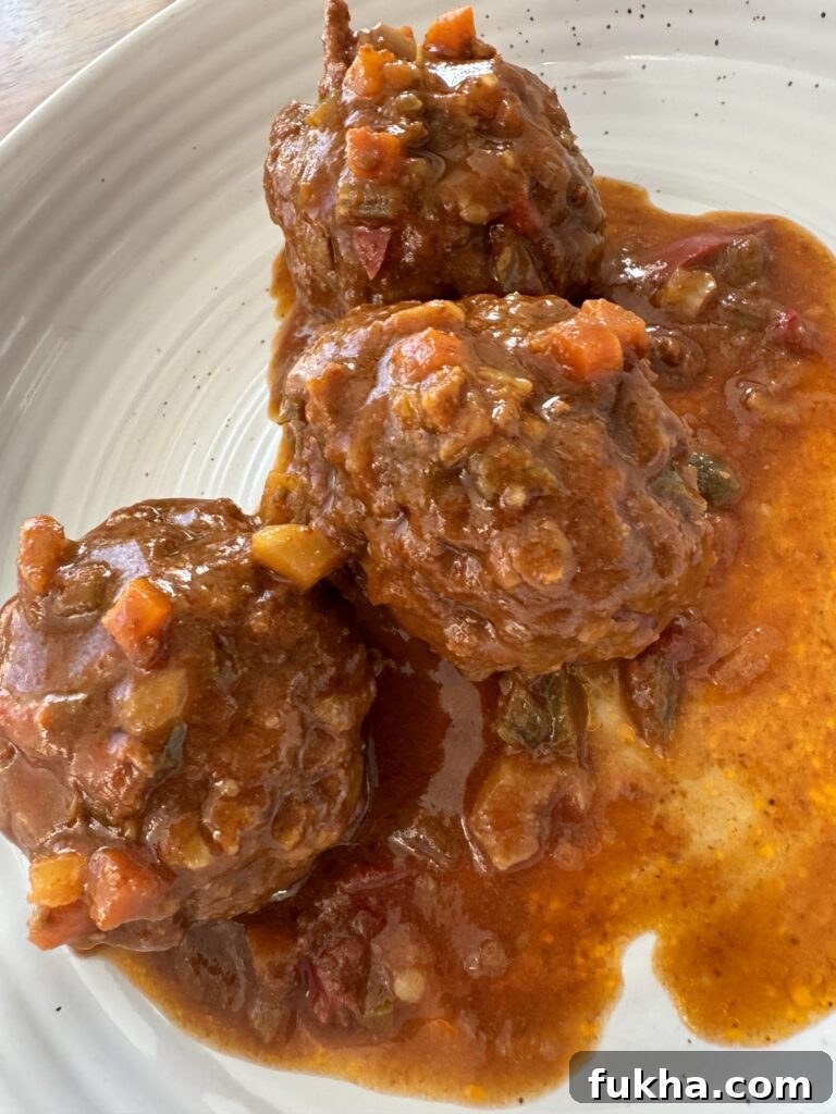 The finished Italian meatballs on a plate covered in sauce