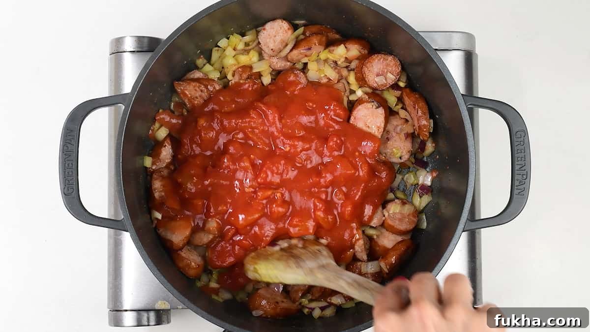 Cooking tomato and sausage pasta sauce in a pot