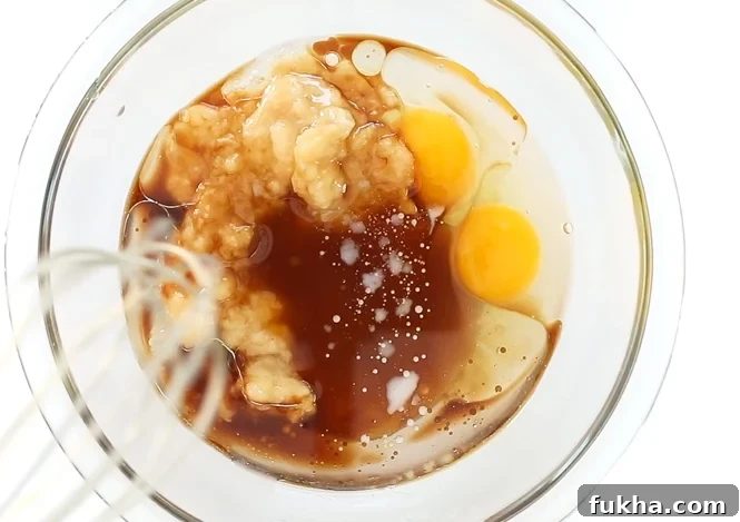 Combining wet ingredients in large bowl | chefsavvy.com Mixing wet ingredients in a large mixing bowl.