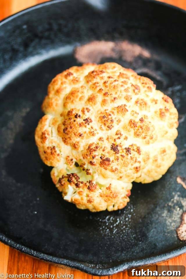Roasted Whole Cauliflower with Pistachio Herb Sauce - this is so easy to make; you can present the whole roasted cauliflower and break it up at the table