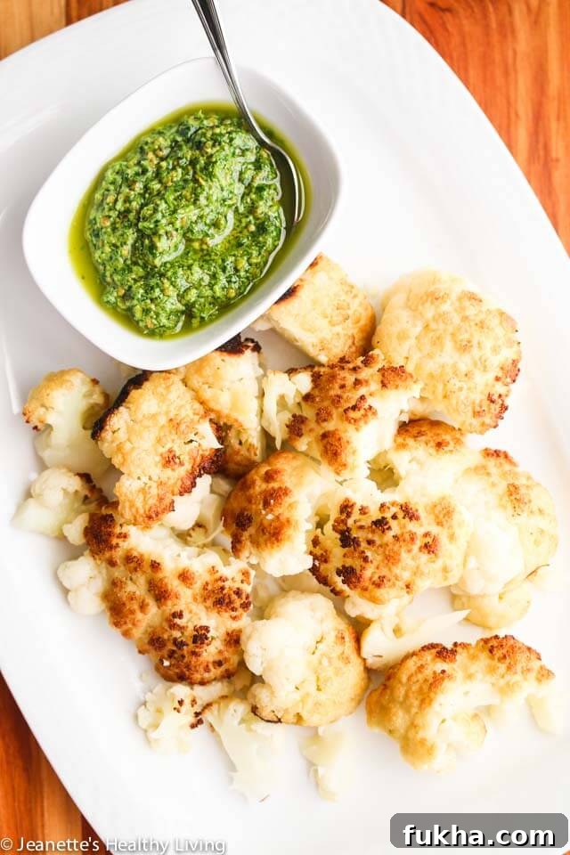 Roasted Whole Cauliflower with Pistachio Herb Sauce - this is so easy to make; you can present the whole roasted cauliflower and break it up at the table
