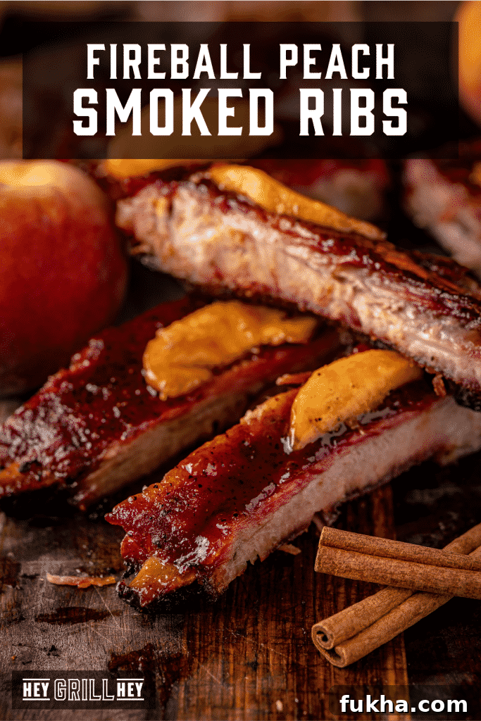 Fireball smoked ribs stacked on a cutting board with text overlay - Fireball Peach Smoked Ribs.